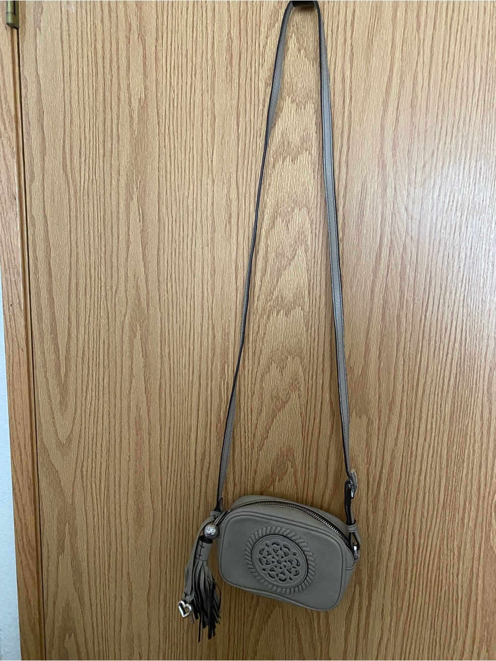 Brighton Tan Leather Crossbody Bag with Tassel and Decorative Medallion